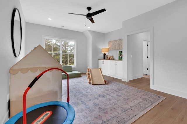 playroom with baseboards, recessed lighting, ceiling fan, and wood finished floors