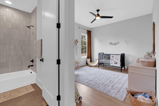 full bathroom featuring baseboards, a ceiling fan, and shower / washtub combination
