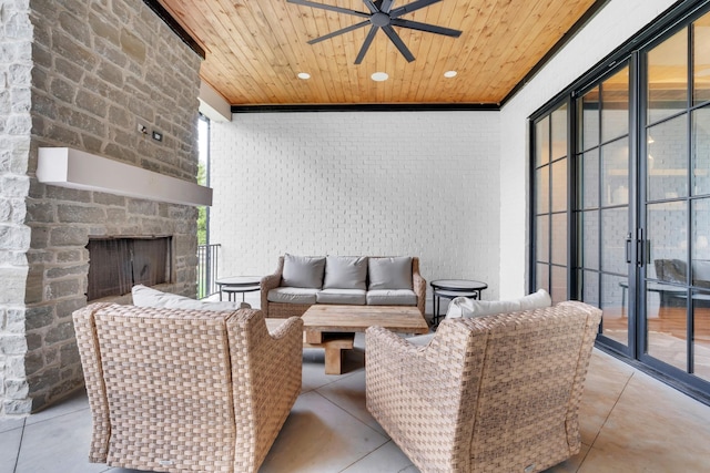 view of patio with a ceiling fan and an outdoor living space with a fireplace