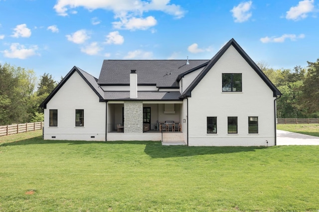 rear view of house with crawl space, a chimney, a patio area, fence, and a yard