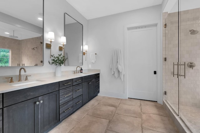 bathroom with double vanity, recessed lighting, a shower stall, and a sink