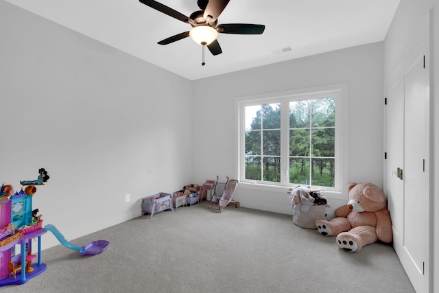 playroom with ceiling fan, carpet flooring, and visible vents