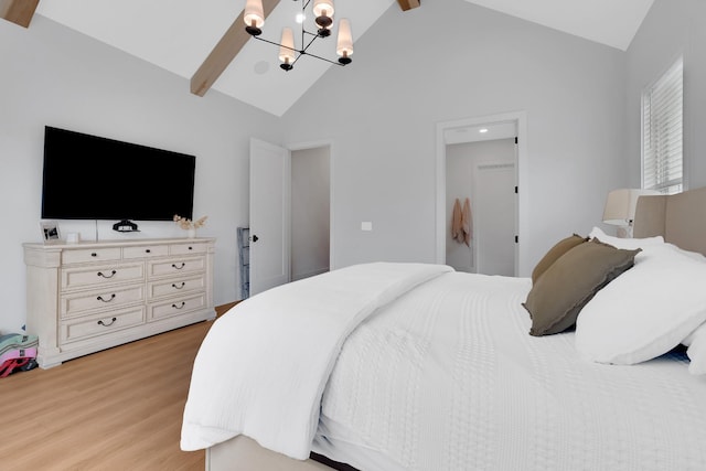 bedroom with beamed ceiling, a chandelier, light wood-style flooring, and high vaulted ceiling