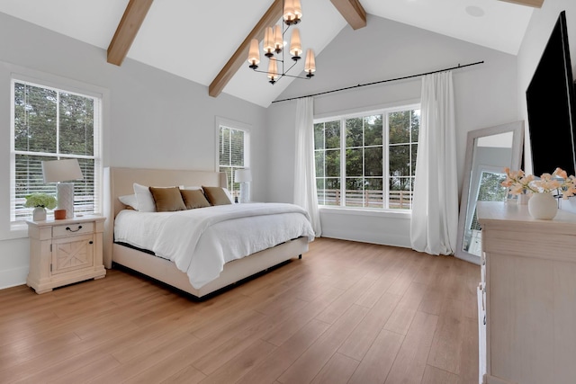 bedroom featuring an inviting chandelier, light wood-style floors, and multiple windows