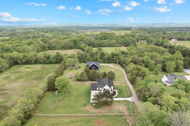 aerial view featuring a wooded view