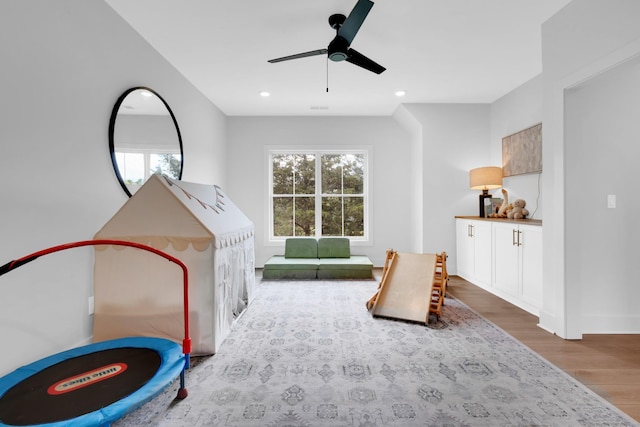 recreation room with recessed lighting, a ceiling fan, and wood finished floors