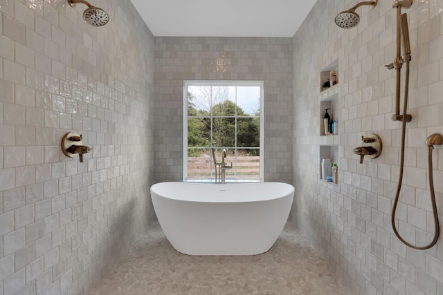 full bathroom with tile walls, tiled shower, and a freestanding bath