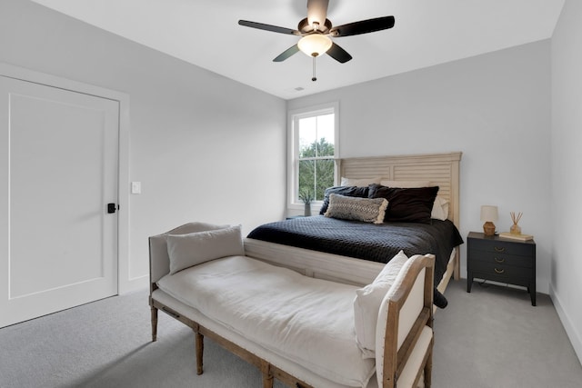 bedroom featuring baseboards, visible vents, a ceiling fan, and light colored carpet