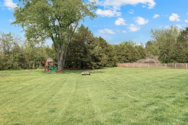 view of yard with a playground and fence