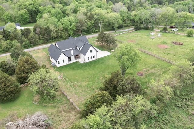 drone / aerial view featuring a forest view