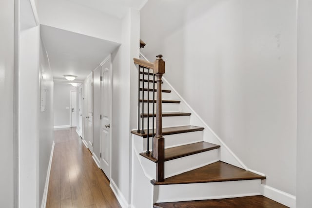 stairs featuring baseboards and wood finished floors