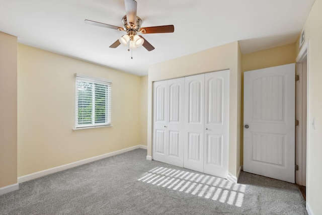 unfurnished bedroom featuring a ceiling fan, visible vents, carpet floors, baseboards, and a closet