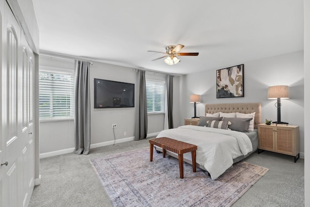 carpeted bedroom featuring a ceiling fan and baseboards