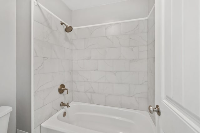 full bath featuring toilet and bathing tub / shower combination