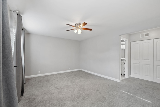 unfurnished bedroom featuring baseboards, carpet, and visible vents