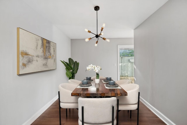 dining area with baseboards, dark wood-style floors, and a chandelier