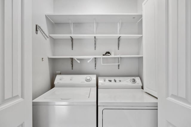 washroom with separate washer and dryer and laundry area