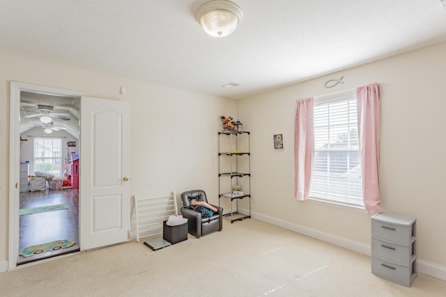 misc room with baseboards, a ceiling fan, and carpet flooring