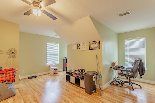 home office featuring visible vents, a ceiling fan, baseboards, and wood finished floors