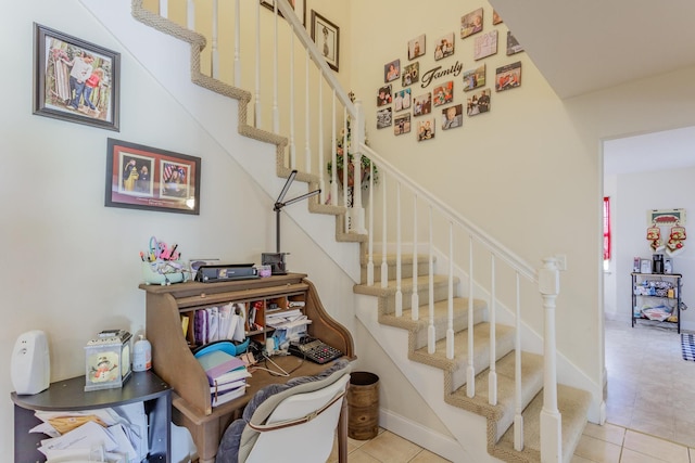 stairway with tile patterned floors
