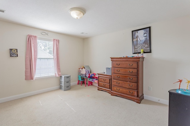 carpeted bedroom featuring baseboards and visible vents