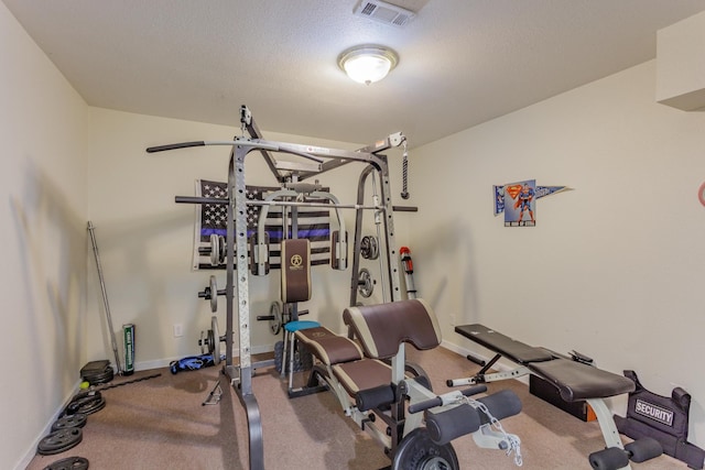 exercise room with baseboards, carpet, and visible vents