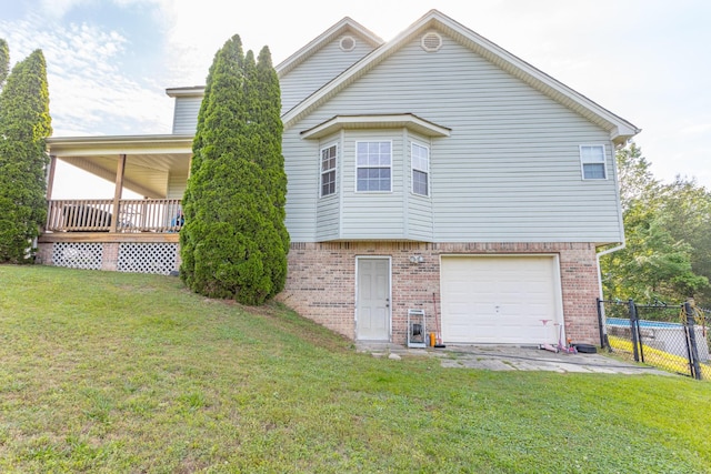 exterior space featuring brick siding, a lawn, and fence
