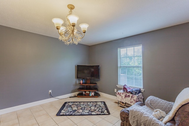 living area featuring tile patterned floors, baseboards, and a notable chandelier