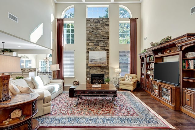 5028 Rockport Ave, Franklin, TN 37064 - living room with dark wood-style flooring, a high ceiling, visible vents, and a stone fireplace