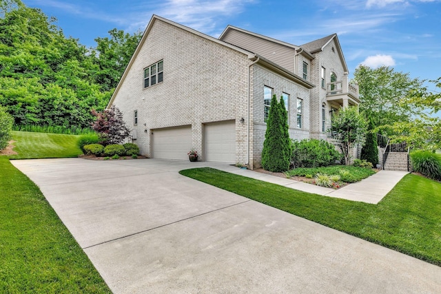 5028 Rockport Ave, Franklin, TN 37064 - view of home's exterior with a lawn, brick siding, an attached garage, and driveway