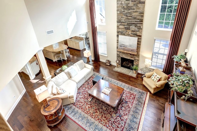5028 Rockport Ave, Franklin, TN 37064 - living area with baseboards, a towering ceiling, ornate columns, visible vents, and dark wood-style floors