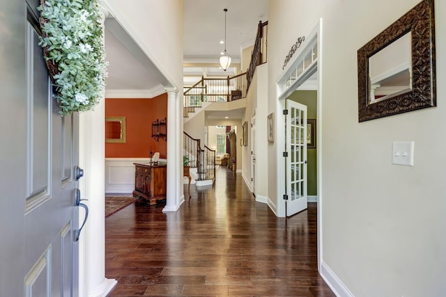 5028 Rockport Ave, Franklin, TN 37064 - foyer featuring crown molding, ornate columns, stairs, and dark wood-type flooring