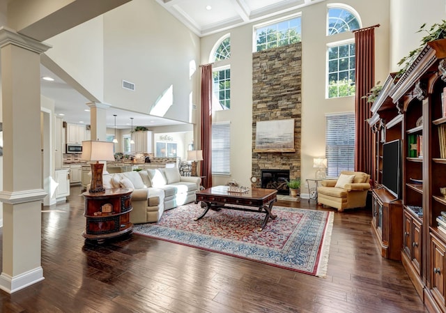 5028 Rockport Ave, Franklin, TN 37064 - living room with a healthy amount of sunlight, a high ceiling, ornate columns, and a stone fireplace
