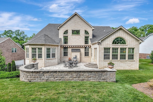 5028 Rockport Ave, Franklin, TN 37064 - rear view of property with a lawn, brick siding, fence, a patio, and a shingled roof