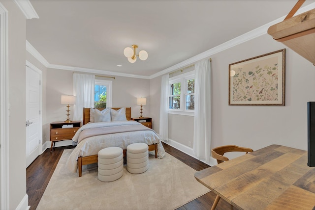 bedroom featuring crown molding, baseboards, multiple windows, and wood finished floors