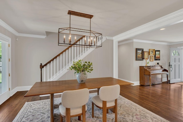 dining area featuring a healthy amount of sunlight, stairs, and wood finished floors