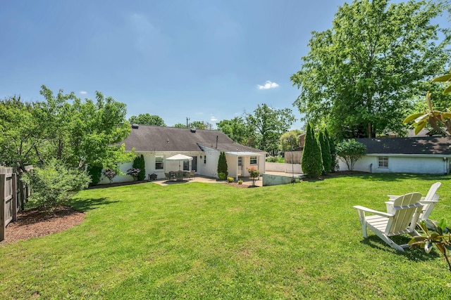 back of property featuring a lawn, a patio, and a fenced backyard
