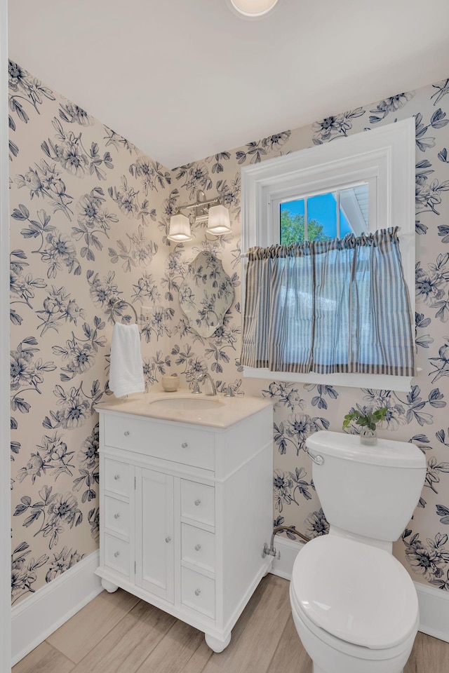 half bath with wallpapered walls