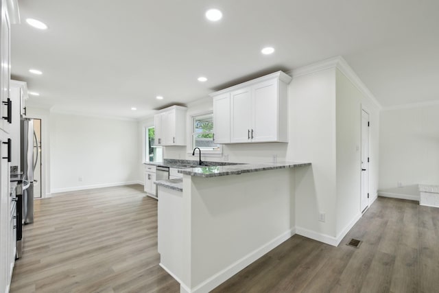 208 Linger Ln, Lebanon, TN 37087 - kitchen with crown molding, light stone countertops, white cabinetry, baseboards, and light wood-type flooring