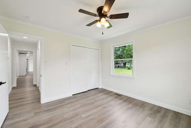 208 Linger Ln, Lebanon, TN 37087 - unfurnished bedroom featuring light wood finished floors, ornamental molding, baseboards, a closet, and a ceiling fan