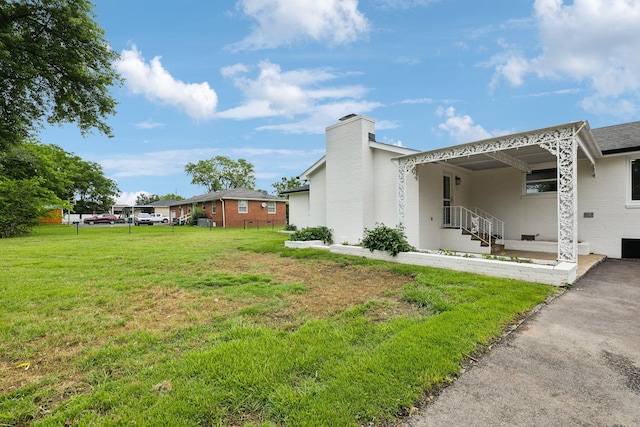 208 Linger Ln, Lebanon, TN 37087 - view of side of home with a chimney, a yard, and brick siding
