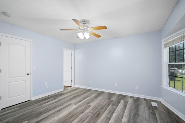 6241 Eskew Dr, Columbia, TN 38401 - unfurnished bedroom featuring dark wood-type flooring, baseboards, and a ceiling fan