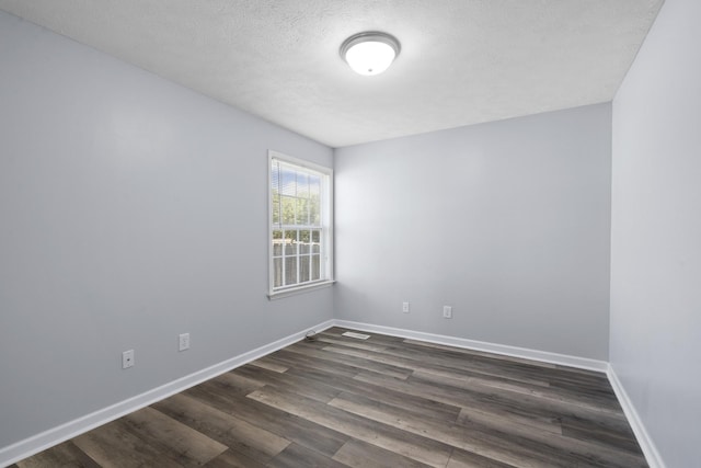 6241 Eskew Dr, Columbia, TN 38401 - spare room with dark wood-type flooring, baseboards, and a textured ceiling
