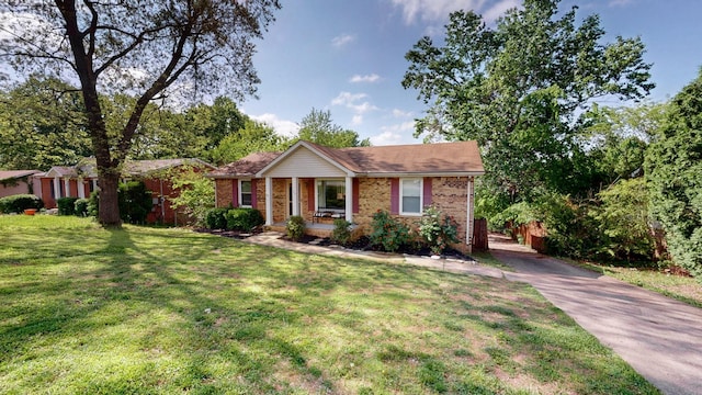 340 Jackson Rd, Clarksville, TN 37042 - ranch-style home with brick siding, driveway, covered porch, and a front yard