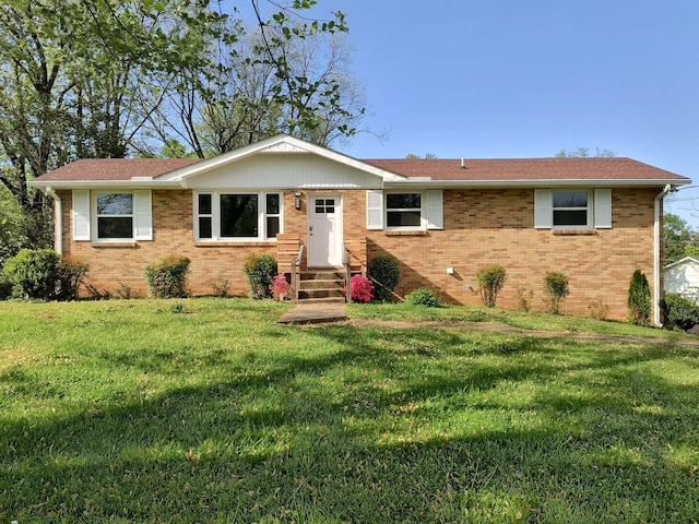 ranch-style house with brick siding, entry steps, and a front lawn