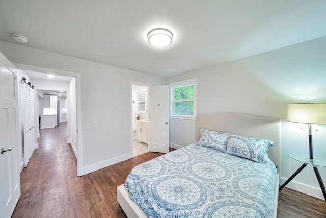 210 NW Clearview Dr, Mount Juliet, TN 37122 - bedroom featuring baseboards, wood finished floors, and connected bathroom
