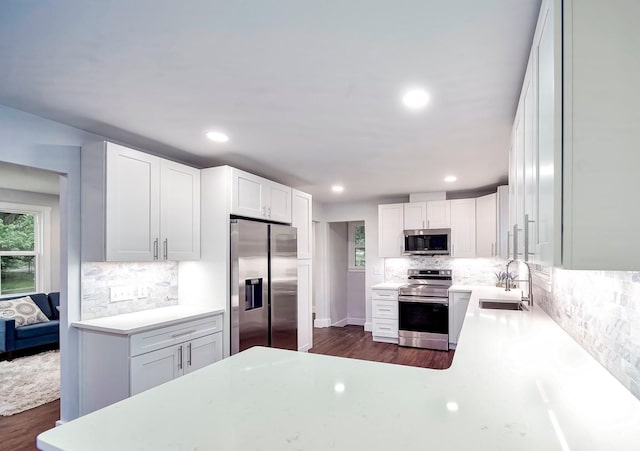 210 NW Clearview Dr, Mount Juliet, TN 37122 - kitchen with appliances with stainless steel finishes, a sink, decorative backsplash, white cabinets, and dark wood-style flooring