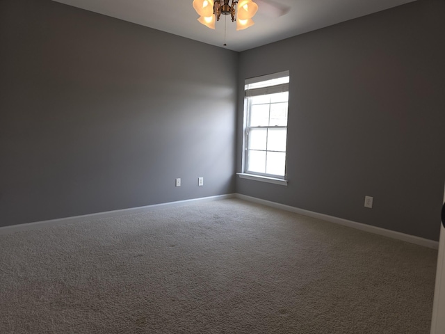 empty room featuring baseboards, a ceiling fan, and carpet flooring