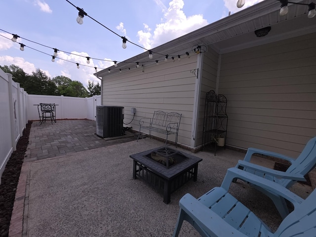 view of patio / terrace with central air condition unit and a fenced backyard