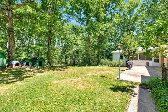 107 Leslie Ln, Hohenwald, TN 38462 - view of yard with a sunroom and a patio area